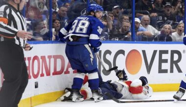 Tampa Bay Lightning left wing Brandon Hagel (38) takes down Florida Panthers center Aleksander Barkov during the third period in Game 2 of an NHL hockey Stanley Cup first-round playoff series, Thursday, April 24, 2025, in Tampa, Fla. (AP Photo/Chris O'Meara)