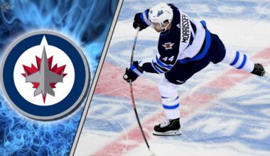 Winnipeg Jets defenseman Josh Morrissey skating with the puck during an NHL game, quarterbacking the power play.