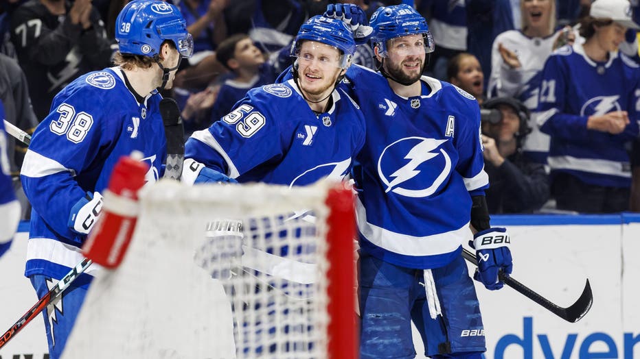 TAMPA, FL - APRIL 13: Jake Guentzel #59 of the Tampa Bay Lightning celebrates a goal with teammates Brandon Hagel #38 and Nikita Kucherov #86 against the Buffalo Sabres at Amalie Arena on April 13, 2025 in Tampa, Florida. (Photo by Mark LoMoglio/NHLI via Getty Images)