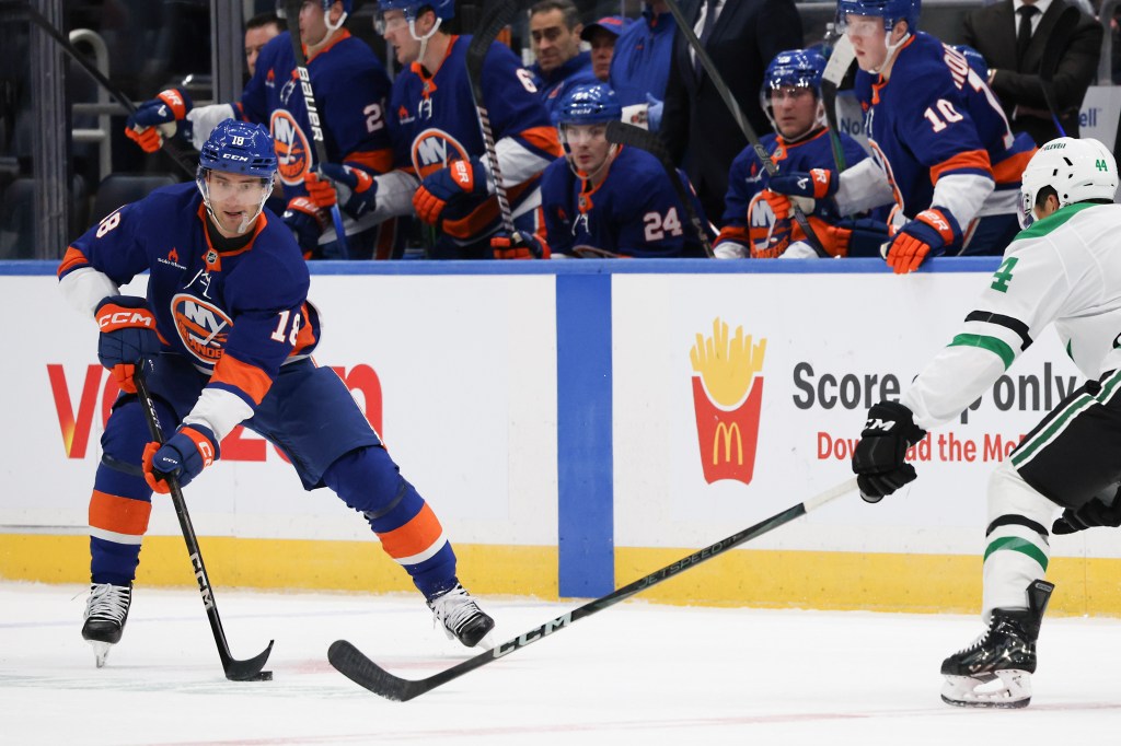 New York Islanders' Pierre Engvall #18 handles the puck while Dallas Stars' Cody Ceci #44 defends during the first period of an NHL game at UBS Arena in Elmont, N.Y. on Sunday, Feb. 23, 2025.