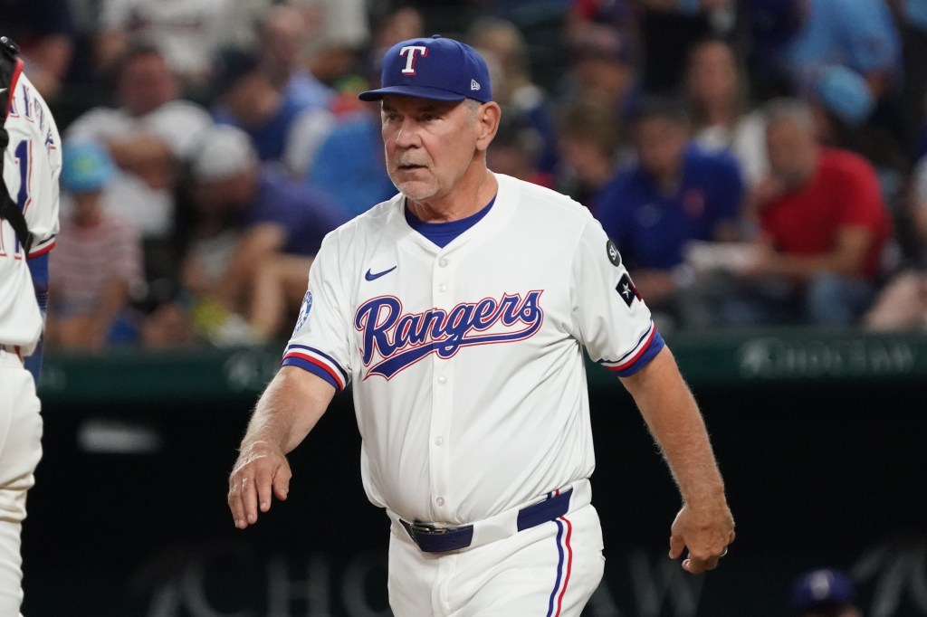 Texas Rangers manager Bruce Bochy walks to the mound for a pitching change.
