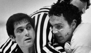 Tiger Williams fighting another player with the referee separating them