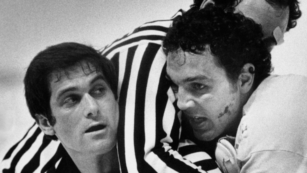 Tiger Williams fighting another player with the referee separating them