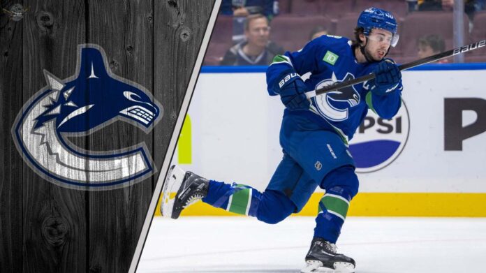 Vancouver Canucks captain Quinn Hughes skating during an NHL game, looking focused on the play