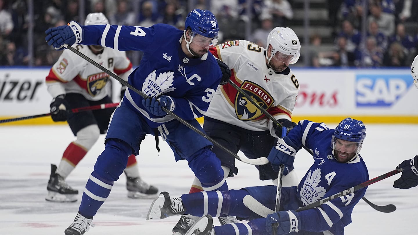 May 14, 2025; Toronto, Ontario, CAN; Toronto Maple Leafs forward Auston Matthews (34) and forward John Tavares (91)  and Florida Panthers forward Brad Marchand (63) battle for a puck during the second period of game five of the second round of the 2025 Stanley Cup Playoffs at Scotiabank Arena. Mandatory Credit: John E. Sokolowski-Imagn Images