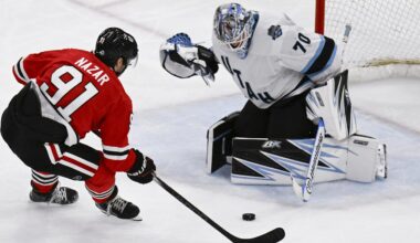 Mar 30, 2025; Chicago, Illinois, USA;  Chicago Blackhawks center Frank Nazar (91) shoots against Utah Hockey Club goaltender Karel Vejmelka (70) during the second period at United Center. Mandatory Credit: Matt Marton-Imagn Images