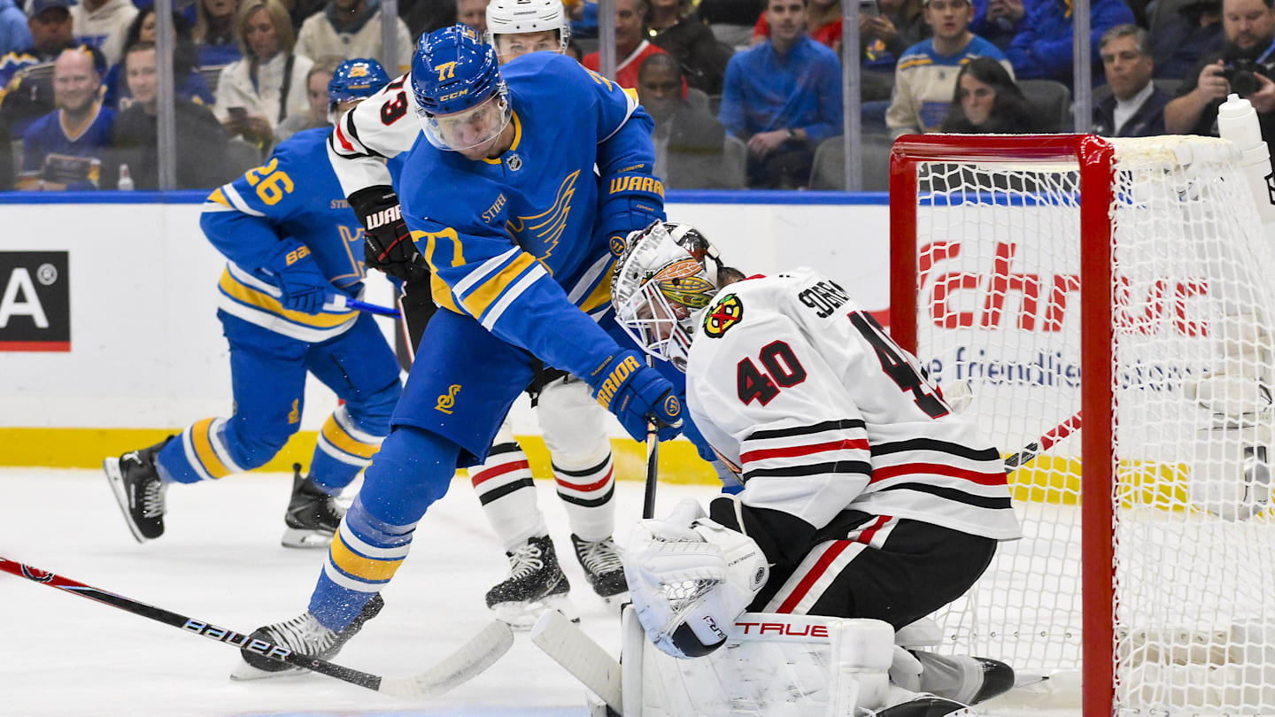 Oct 15, 2025; St. Louis, Missouri, USA; St. Louis Blues center Nick Bjugstad (77) shoots against Chicago Blackhawks goaltender Arvid Soderblom (40) during the first period at Enterprise Center. Mandatory Credit: Jeff Curry-Imagn Images