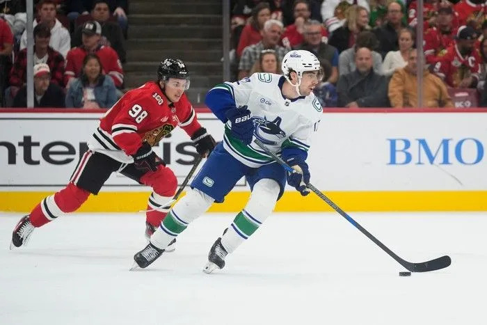  Chicago Blackhawks centre Connor Bedard chases Vancouver Canucks centre Filip Chytil, right, during the first period of an NHL hockey game Friday, Oct. 17.