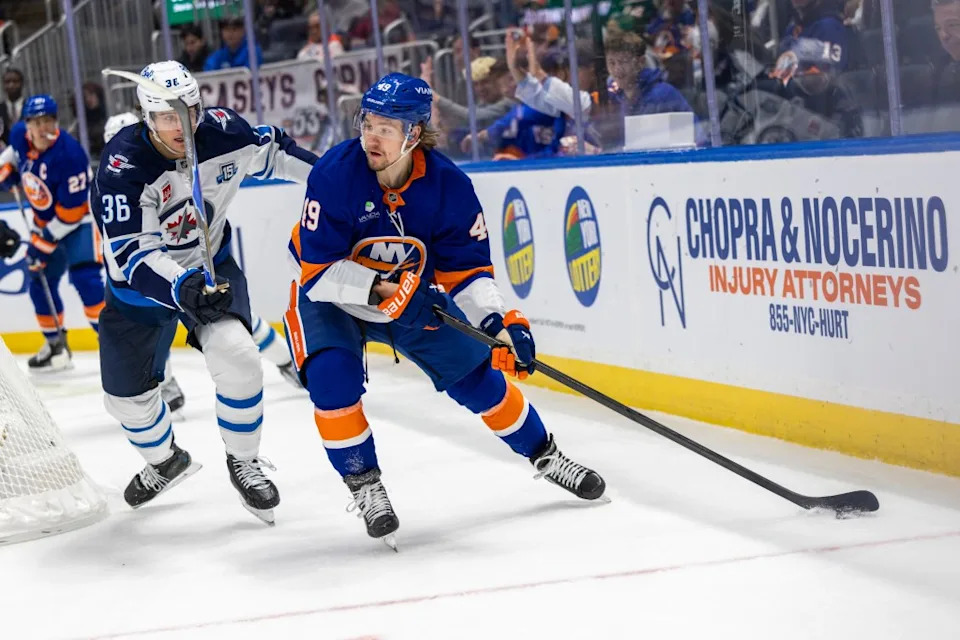 Max Shabanov of the New York Islanders moves the puck down ice as Morgan Barron of the Winnipeg Jets gives chase during the third period at UBS Arena, Monday, Oct. 13, 2025, in Elmont, NY. Corey Sipkin for the NY POST