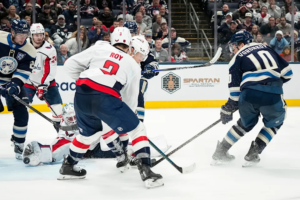 Columbus Blue Jackets left wing Dmitri Voronkov (10) kicks a puck past Washington Capitals goaltender Logan Thompson (48) during the third period of the NHL hockey game at Nationwide Arena in Columbus on Oct. 24, 2025. The goal was disallowed after review. The Blue Jackets lost 5-1.