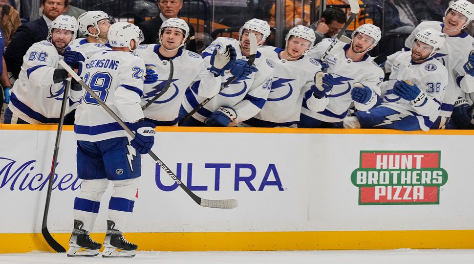 Tampa Bay Lightning center Zemgus Girgensons (28) celebrates his goal with teammates during the first period of an NHL hockey game against the Nashville Predators, Tuesday, Oct. 28, 2025, in Nashville, Tenn. (AP Photo/George Walker IV)