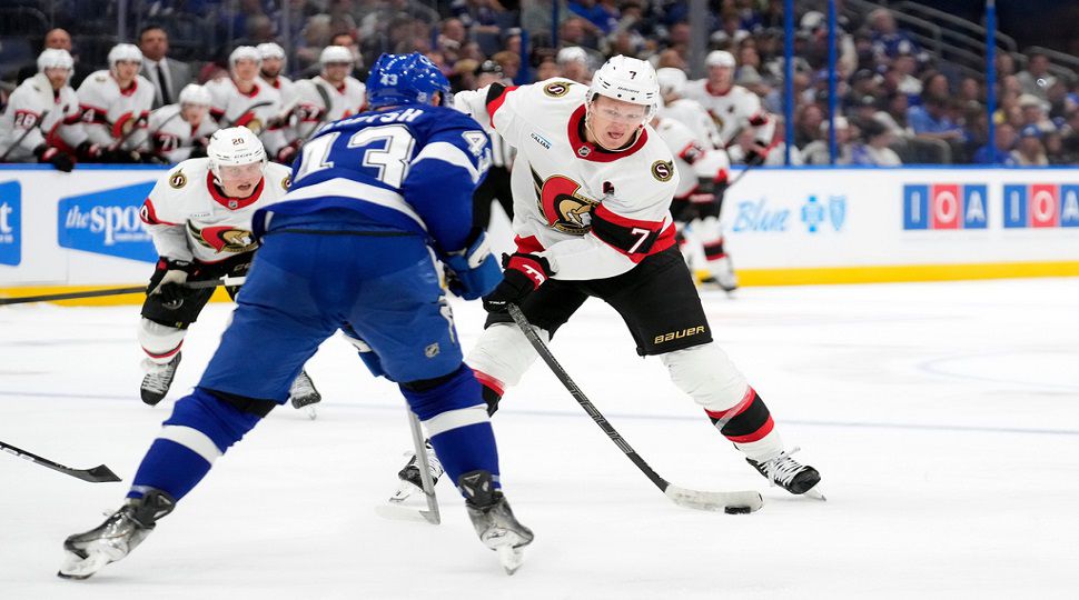 Ottawa Senators left wing Brady Tkachuk (7) shoots in front of Tampa Bay Lightning defenseman Darren Raddysh (43) during the third period of an NHL hockey game Thursday, Oct. 9, 2025, in Tampa, Fla. (AP Photo/Chris O'Meara)