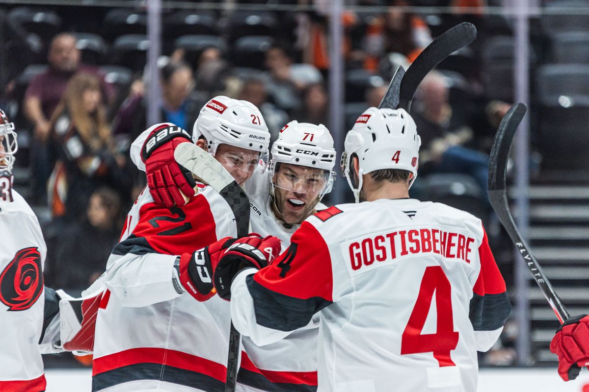 Carolina Hurricanes players celebrate after a win during an NHL game against the Anaheim Ducks on October 16, 2025 in Anaheim, CA.