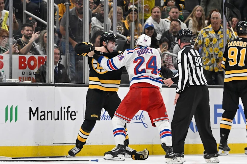 Rangers defenseman Carson Soucy (24) and Boston Bruins center Michael Eyssimont (81) fight during the second period at TD Garden. Eric Canha-Imagn Images