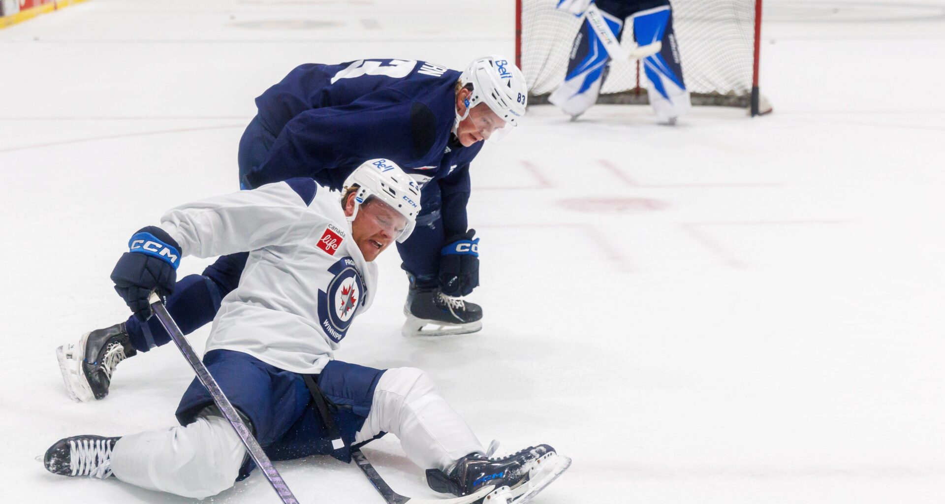 MIKE DEAL / FREE PRESS Winnipeg Jets’ Mason Shaw (23) slips during a battle for the puck with Dylan Anhorn (83) during training camp at Hockey For All Centre this September. Shaw was loaned to the Manitoba Moose for their training camp last week.