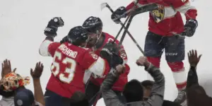Marchand celebrating his OT game-winning goal with Kulikov. (AP Photo/Marta Lavandier)