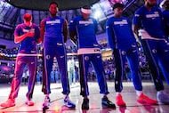 Dallas Mavericks forward Cooper Flagg (left) stands for the national anthem with teammates...
