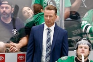 Dallas Stars head coach Glen Gulutzan watches the third period of an NHL preseason game...