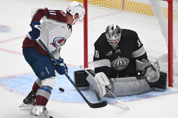 Kings goaltender Darcy Kuemper, right, blocks a shot by the...