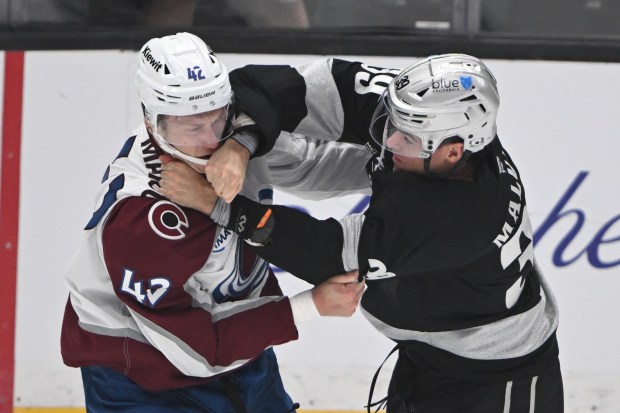 The Kings’ Jeff Malott, right, throws a punch at the...