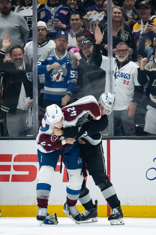 Colorado Avalanche defenseman Josh Manson, left, and Kings left wing...