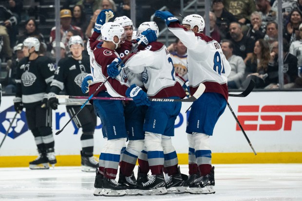 Colorado Avalanche players celebrate a goal by center Martin Necas...