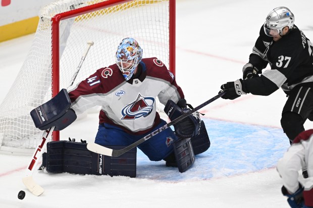 The Kings’ Warren Foegele (37) tries to deflect the puck...