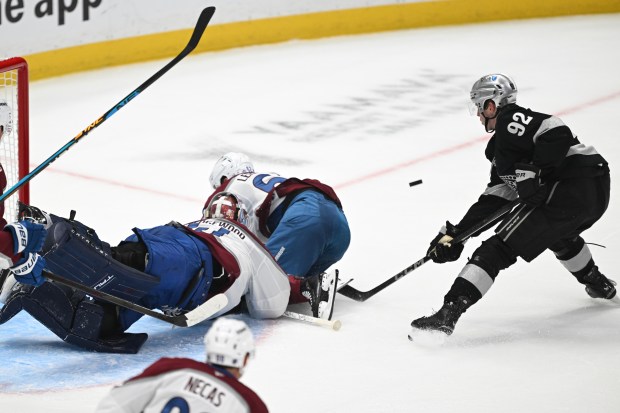 The Kings’ Brandt Clarke, right, takes a shot as Colorado...