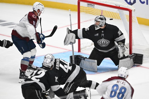 The Colorado Avalanche’s Martin Necas, bottom right, scores past Kings...