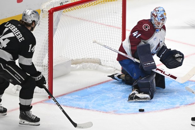 A shot by the Kings’ Alex Laferriere (13) comes up...