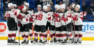 The Devils celebrate their first victory of the season