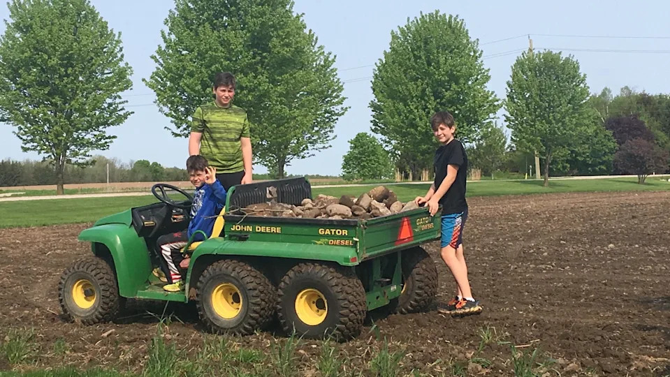 Brady Martin (right) on a grueling stone picking chore with brothers Jordan (left) and Joey (middle) on the Martin family farm in Elmira, Ontario