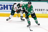 Dallas Stars right wing Mikko Rantanen (96) looks to pass ahead of Minnesota Wild forward...