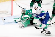 Vancouver Canucks right wing Conor Garland (8) shoots and scores past Dallas Stars...