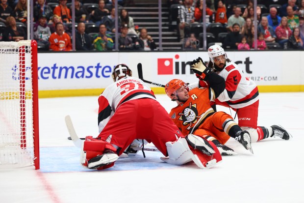 Carolina Hurricanes goaltender Frederik Andersen, left, Ducks center Mason McTavish...