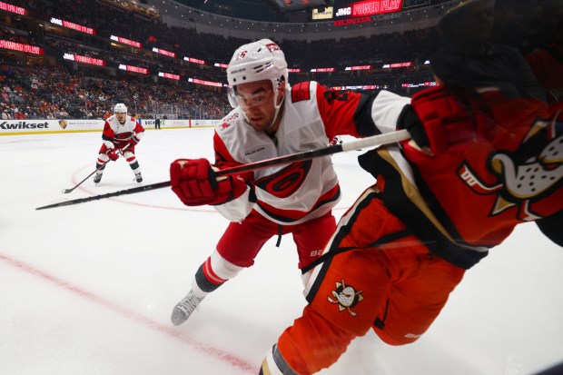 Carolina Hurricanes defenseman Sean Walker (26) collides with Ducks defenseman...