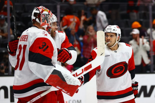 Carolina Hurricanes goaltender Frederik Andersen, left, celebrates with teammates after...