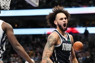 Dallas Mavericks center Dereck Lively II celebrates after a dunk during the first half of an...