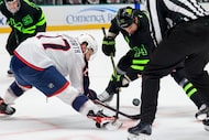 Dallas Stars left wing Jamie Benn (14) faces-off with Columbus Blue Jackets right wing...