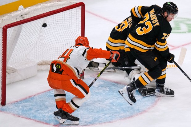 Ducks defenseman Drew Helleson (14) scores against the Boston Bruins...