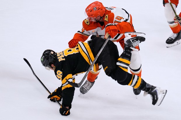 Boston Bruins defenseman Charlie McAvoy (73) is dropped to the...