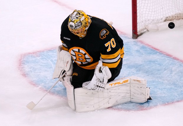 Boston Bruins goaltender Joonas Korpisalo drops to the ice, but...