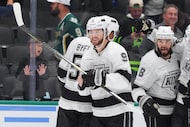 The Los Angeles Kings right wing Adrian Kempe (9) smiles as his teammates celebrate his...