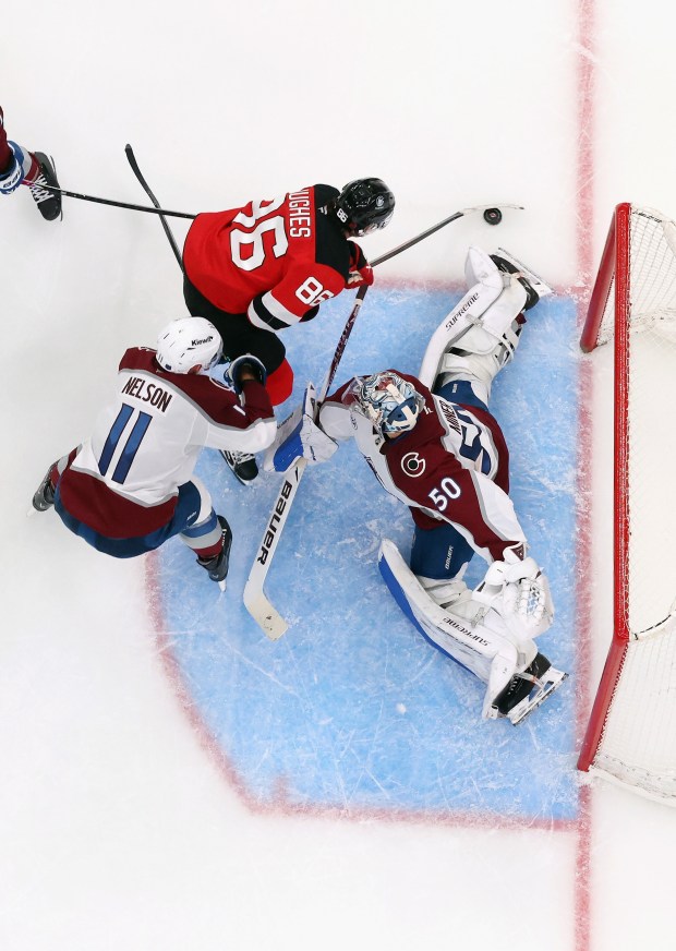 NEWARK, NEW JERSEY - OCTOBER 26: Trent Miner #50 of the Colorado Avalanche makes a save on Jack Hughes #86 of the New Jersey Devils at Prudential Center on October 26, 2025 in Newark, New Jersey. The Devils defeated the Avalanche 4-3 in overtime. (Photo by Bruce Bennett/Getty Images)