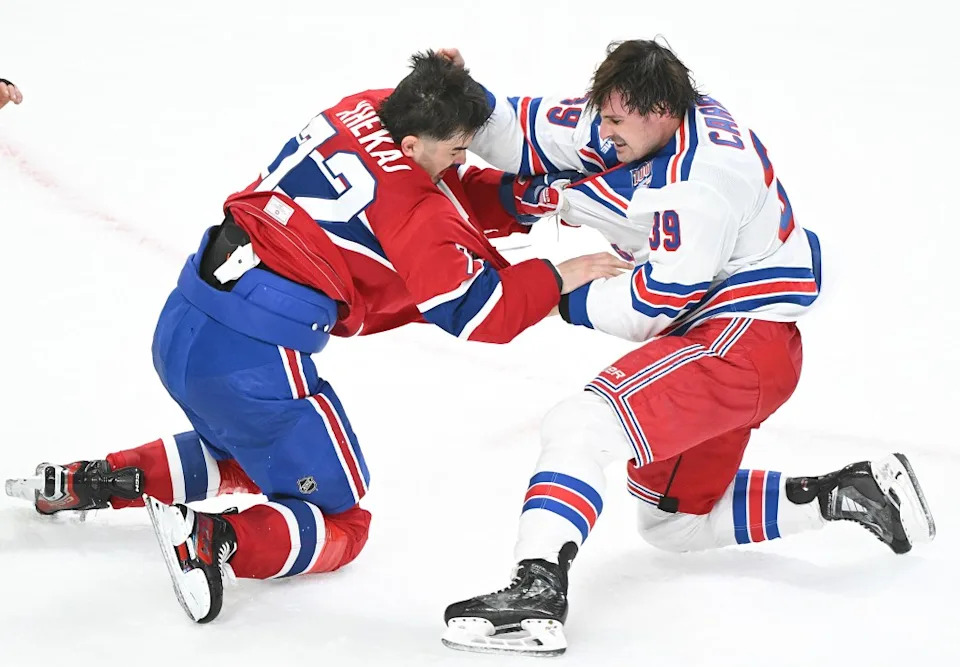Rangers’ Sam Carrick (39) fights with Montreal Canadiens’ Arber Xhekaj (72) during the second period of an NHL hockey game in Montreal, Saturday, Oct. 18, 2025. AP