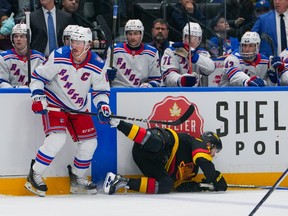 Elias Pettersson is checked by J.T. Miller during the first period