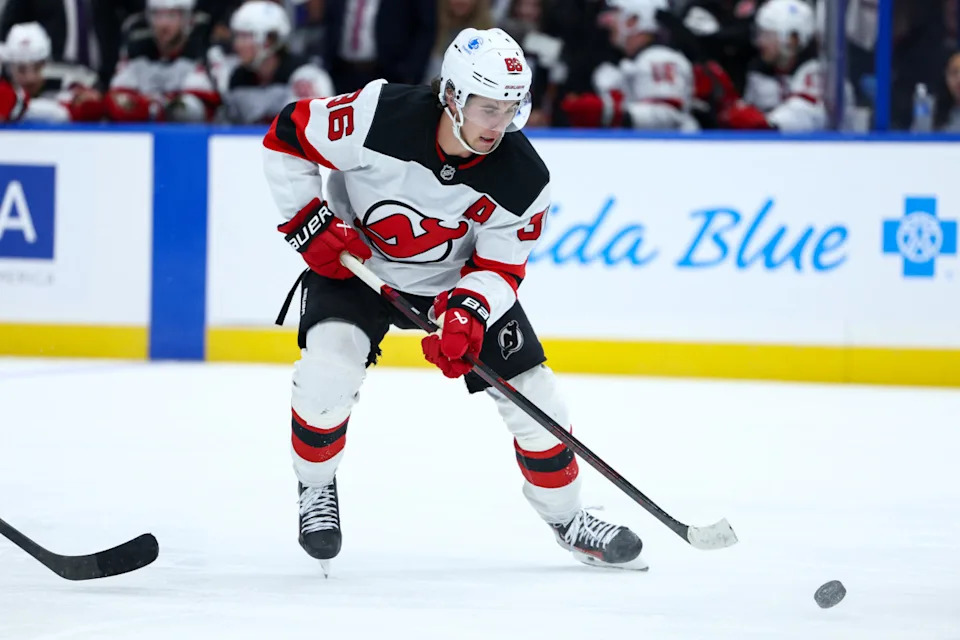 New Jersey Devils center Jack Hughes (86) controls the puck against the Tampa Bay Lightning.Nathan Ray Seebeck-Imagn Images