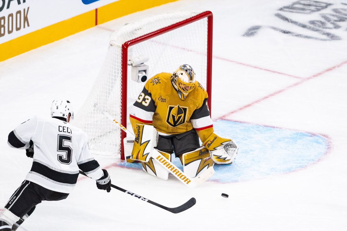 Vegas Golden Knights goalie Adin Hill (33) makes a save on Los Angeles Kings defenseman Cody Ceci (5) during a NHL game between the Vegas Golden Knights and the Los Angeles Kings, Wednesday October 8, 2025 in Las Vegas, Nev.