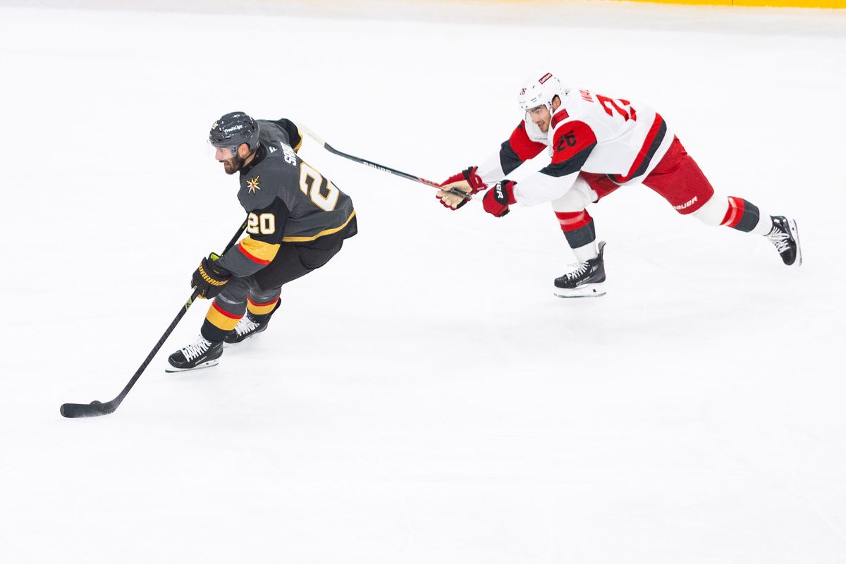 Vegas Golden Knights right-wing Brandon Saad (20) skates the puck into the offensive zone while being chased by Carolina Hurricanes defenseman Sean Walker (26) during a NHL game between the Vegas Golden Knights and the Carolina Hurricanes, Monday October 20, 2025 in Las Vegas, Nev.