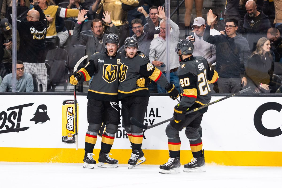 Vegas Golden Knights left-wing Ivan Barbashev (49) (Middle) embraces center Jack Eichel (9) (Left) and left-wing Brandon Saad (Right) after scoring a goal during a NHL game between the Vegas Golden Knights and the Carolina Hurricanes, Monday October 20, 2025 in Las Vegas, Nev.